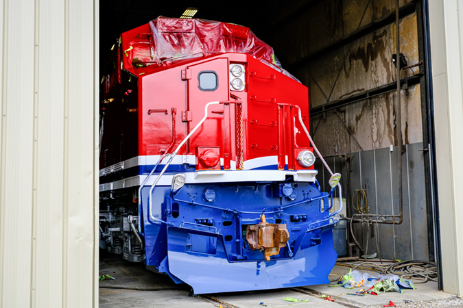 A partially completed locomotive peeks out from the shop. A partially completed locomotive peeks out from the shop.