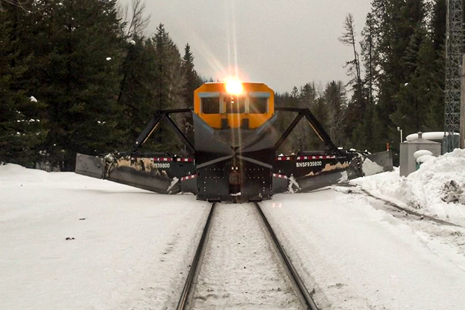 An operating Jordan Spreader pushing aside snow.