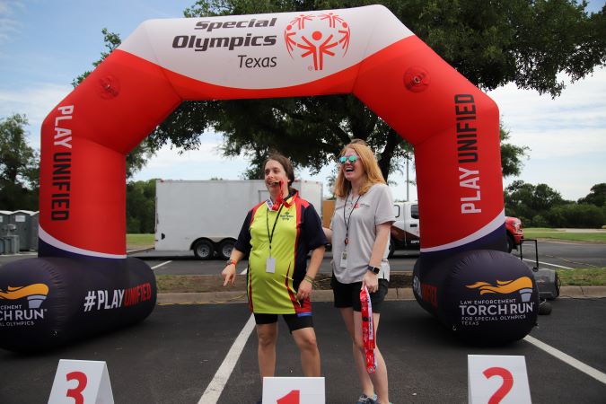 BNSF’s Katie Hower presenting a medal to a Special Olympics athlete. 