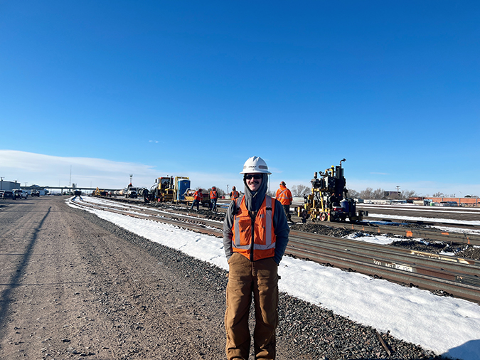 Assistant Roadmaster Brady Sewell, foreground, with orange-marked rail in the background indicating ties to pull. 